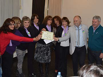 Las organizadoras y Baldo entregan el reconocimiento al doctor Pollono