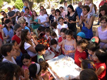 Los chicos alrededor de la torta Cantando el feliz cumpleaos a su Jardin.